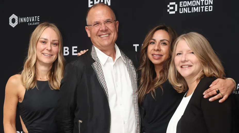 Attendees smiling together at the C-Tribe media wall